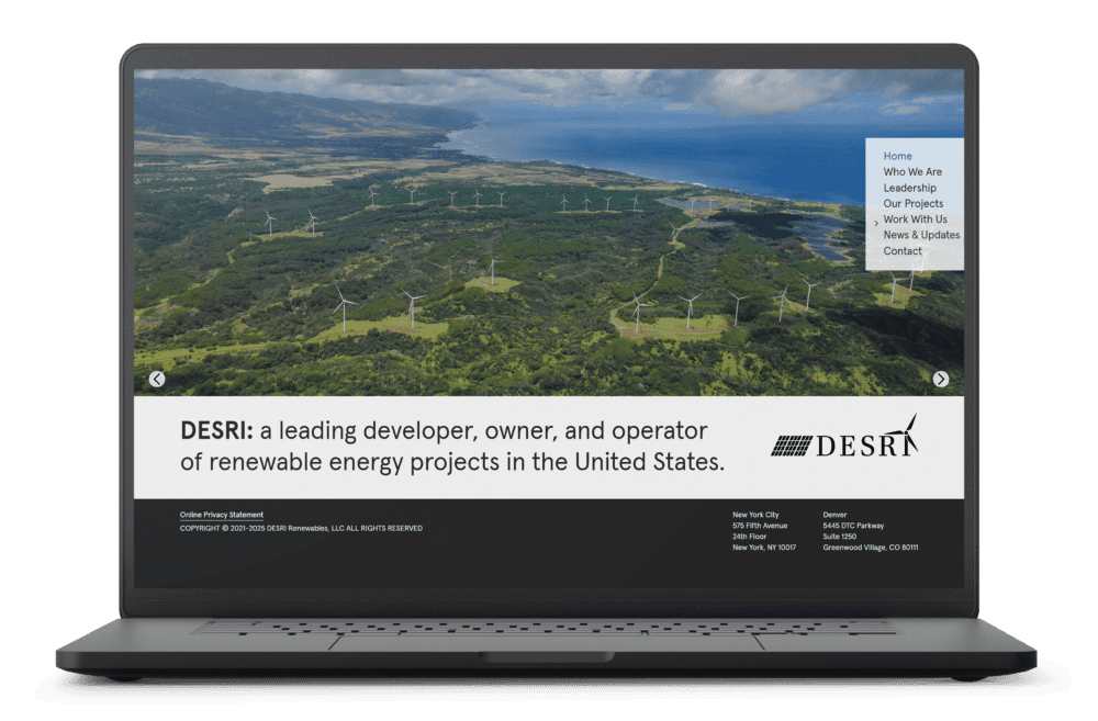 Laptop displaying DESRI website homepage featuring aerial view of a wind farm and text stating DESRI is a leading developer, owner, and operator of renewable energy projects in the United States