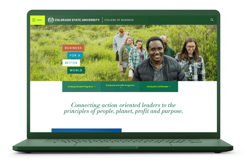 A green laptop displaying the Colorado State University College of Business website, featuring a group of diverse students walking outdoors with a message promoting business for a better world.