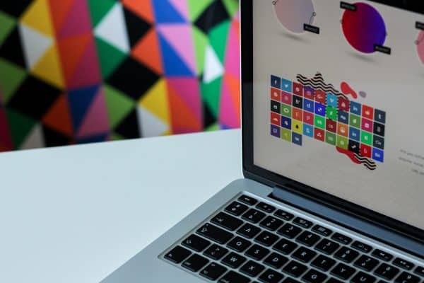 Graphic elements on laptop in front of colorful background