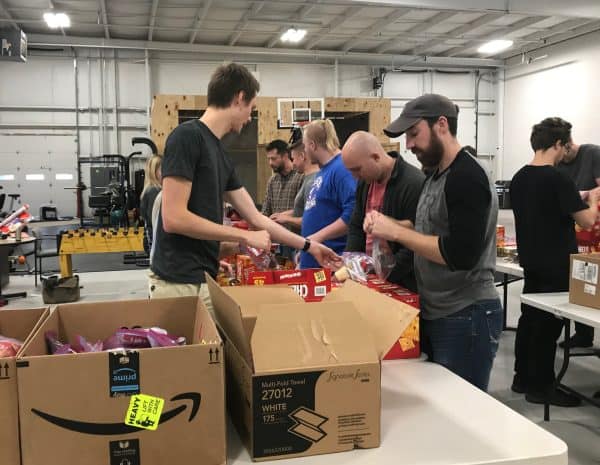 men and women filling food bags