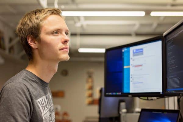 Man looking at monitors