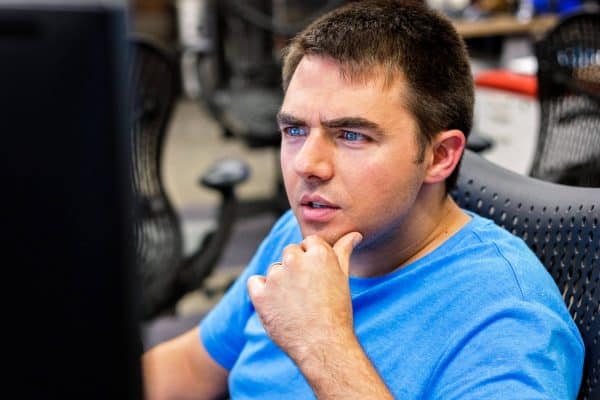 Man in blue shirt looking at monitor