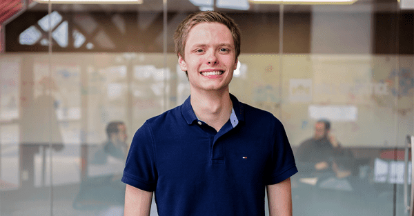 Ben Buurstra standing in front of glass conference room