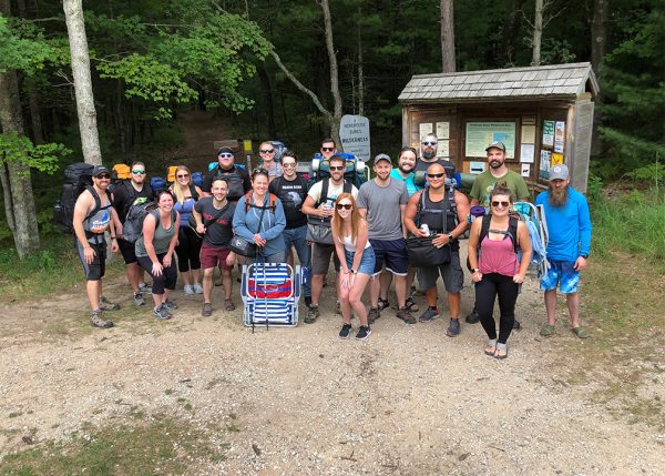 group of people with hiking gear in woods