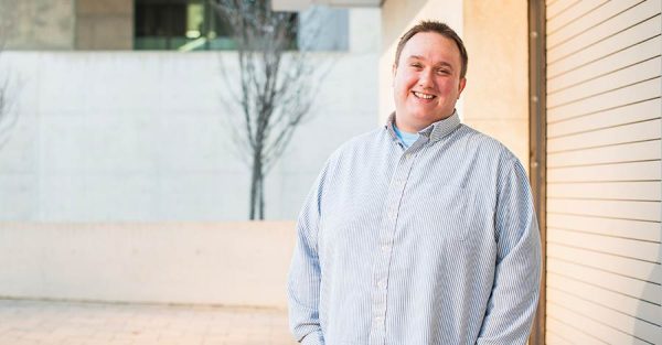 Man standing with hands in pockets