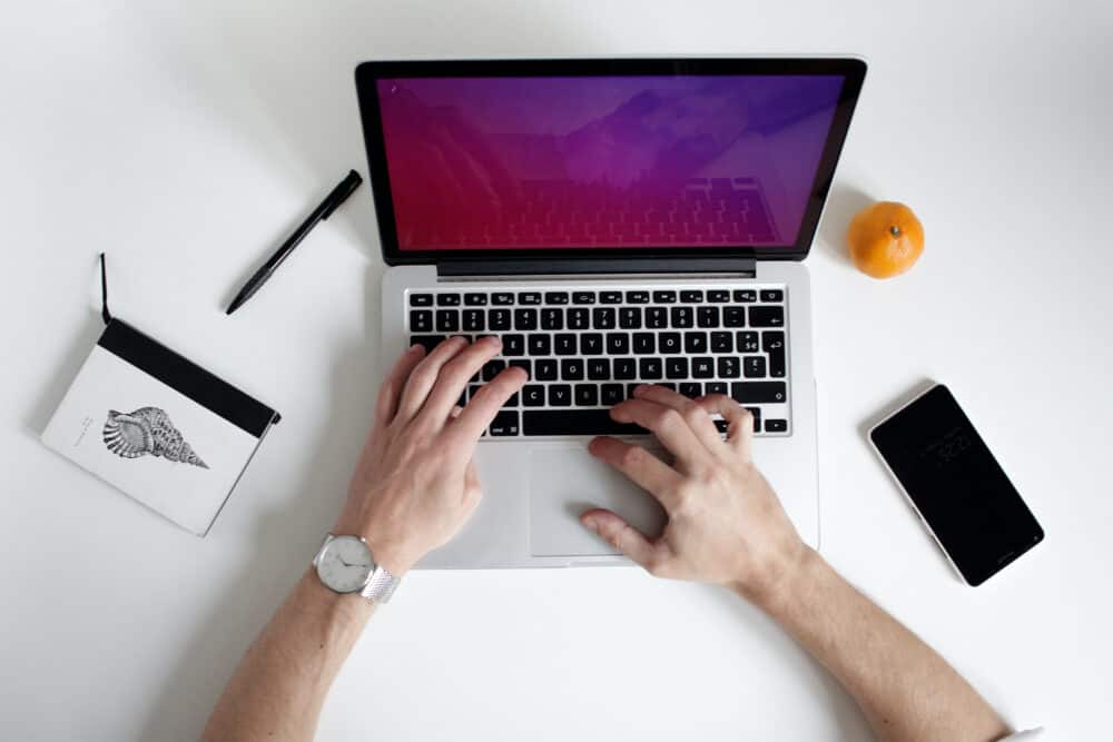 Hands typing on computer