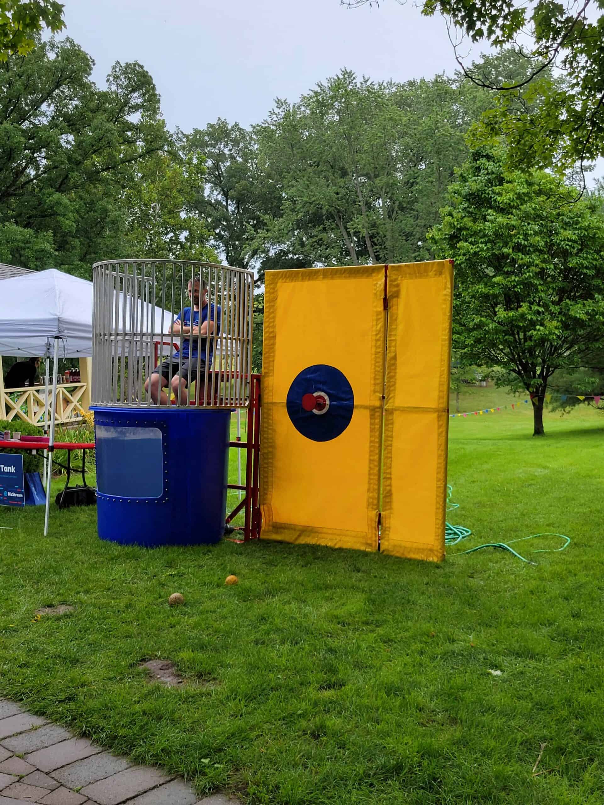 Person throwing a ball at a dunk tank