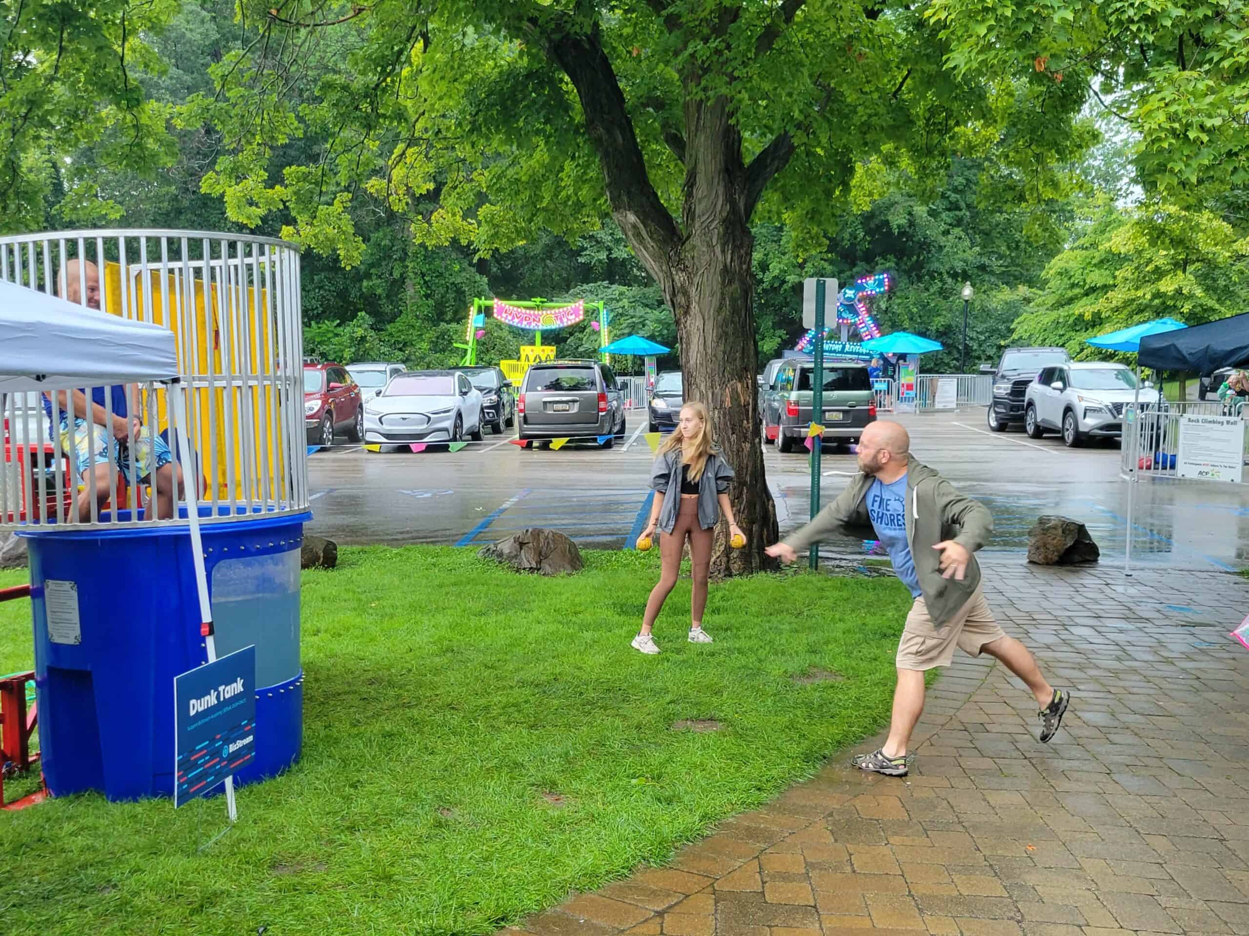 Person throwing a ball at a dunk tank