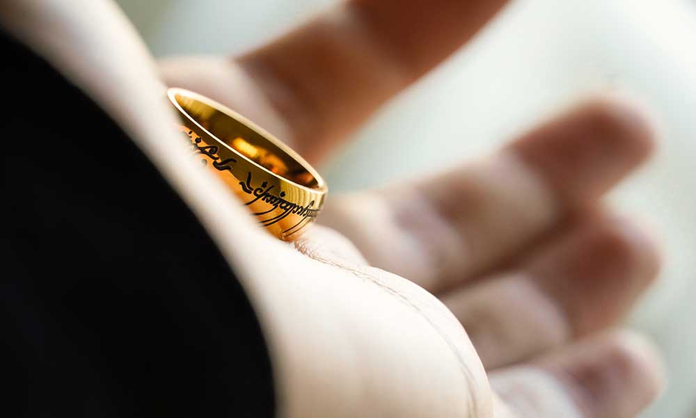 A gold ring laying on a person's hand