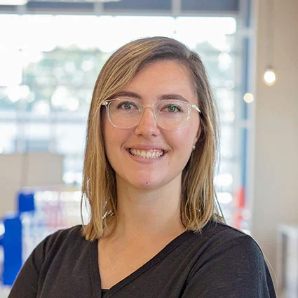 woman with blonde hair and glasses