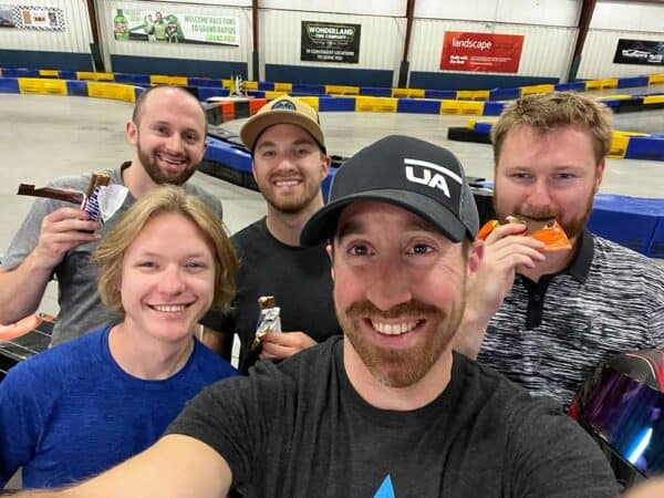 Group of guys at a Go Kart racing track.