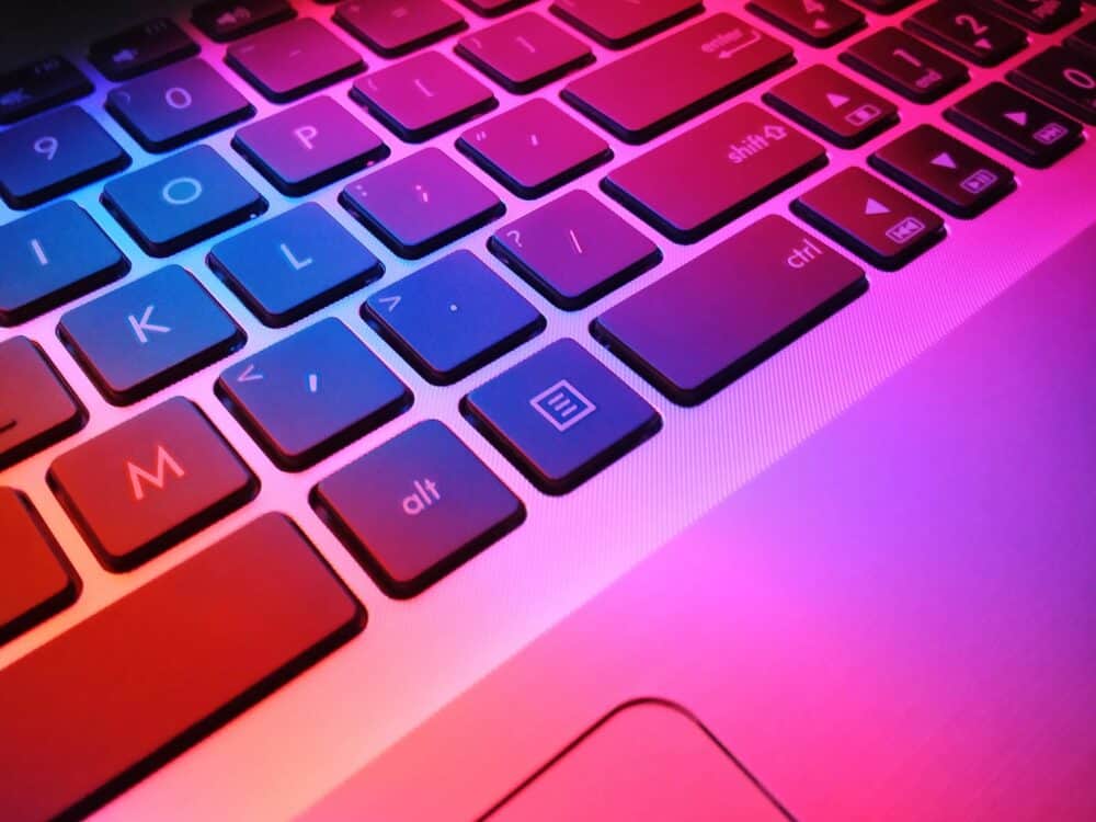 Keyboard with pink and purple light showing on it