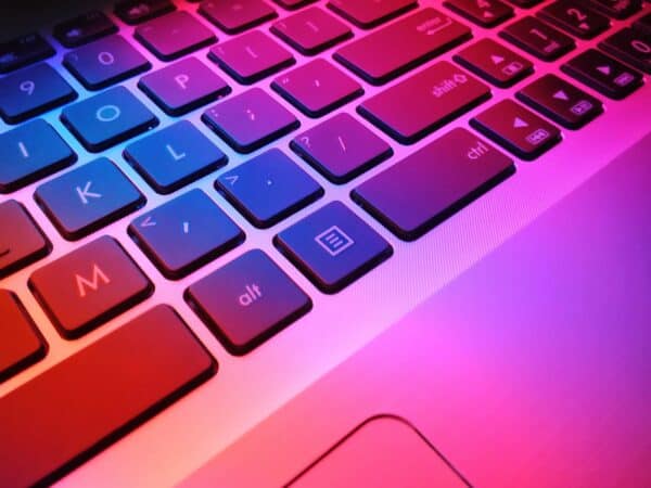 Keyboard with pink and purple light showing on it