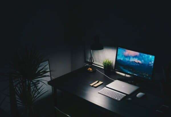 Laptop on a desk in a dark room