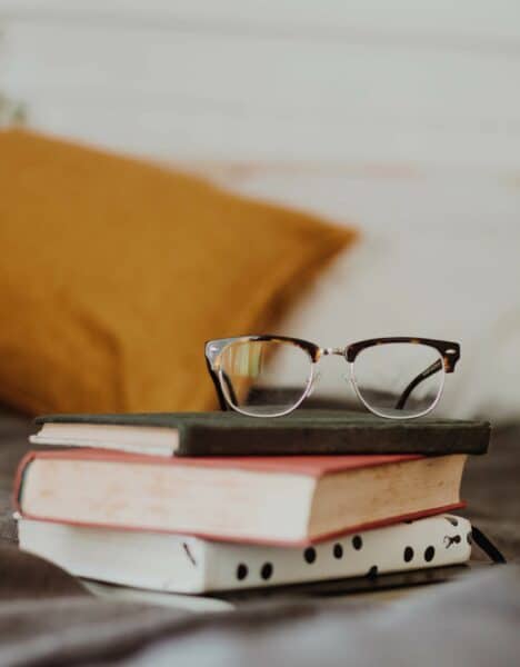 Books with glasses on top