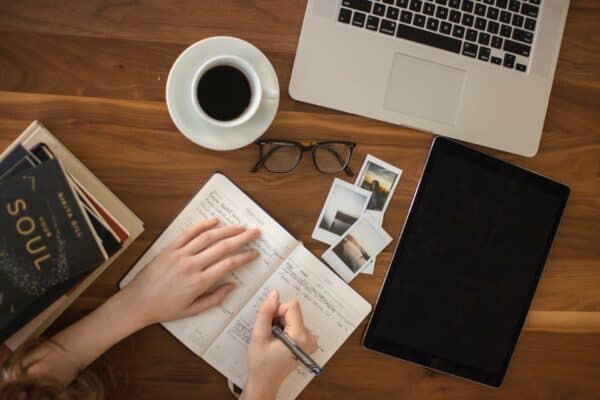 Laptop, coffee, and notebook