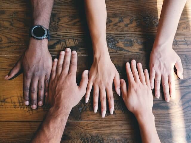 diverse hands on a table