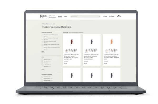 Image of a laptop displaying an online store page for Kolbe Windows and Doors, showcasing window operating hardware products. The page includes filtering options on the left for product type, color, and component, with a grid of product listings in the main section.