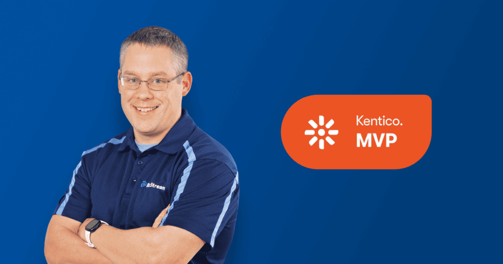 Man smiling with arms crossed on a blue background with Kentico MVP badge