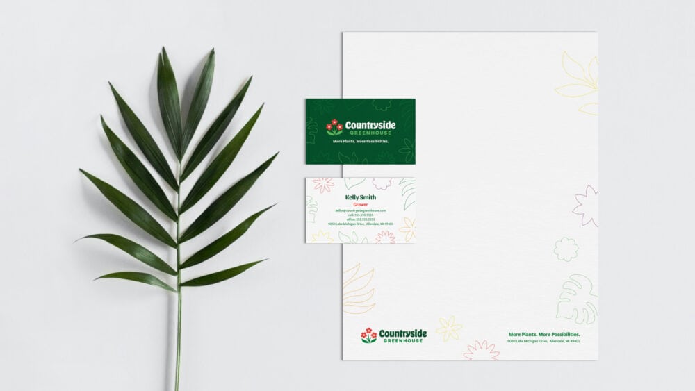 Countryside Greenhouse letterhead and business card next to a leaf