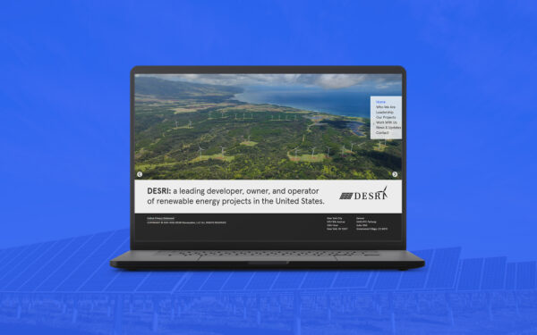 A black laptop displaying the DESRI website, superimposed over a background featuring a blue-tinted image of solar panels, creating a renewable energy-themed promotional image.