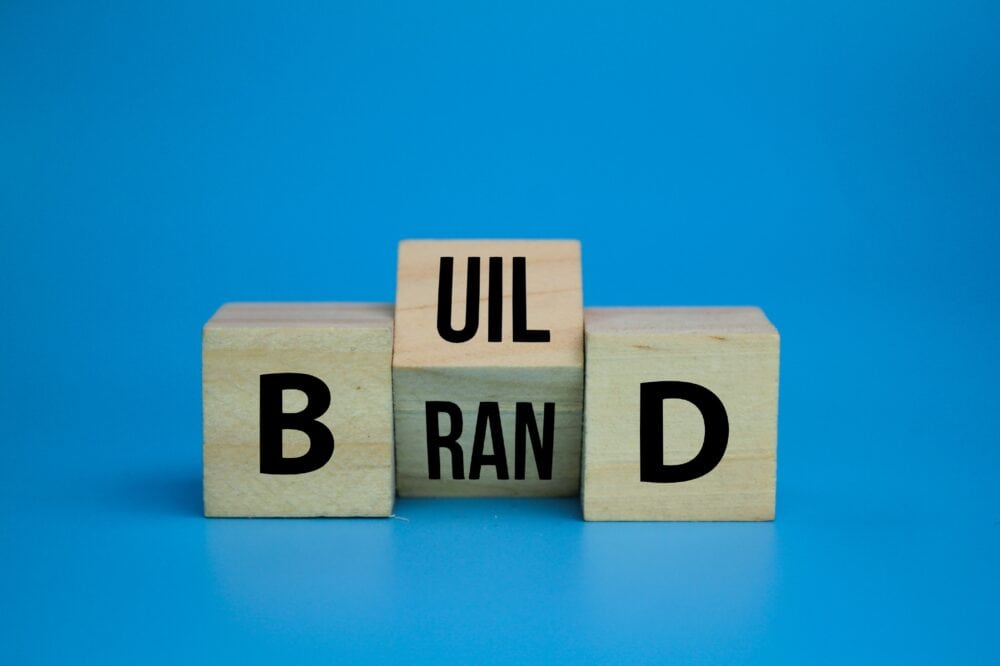 wooden cube with the word Build your brand symbol. the concept of building its own brand