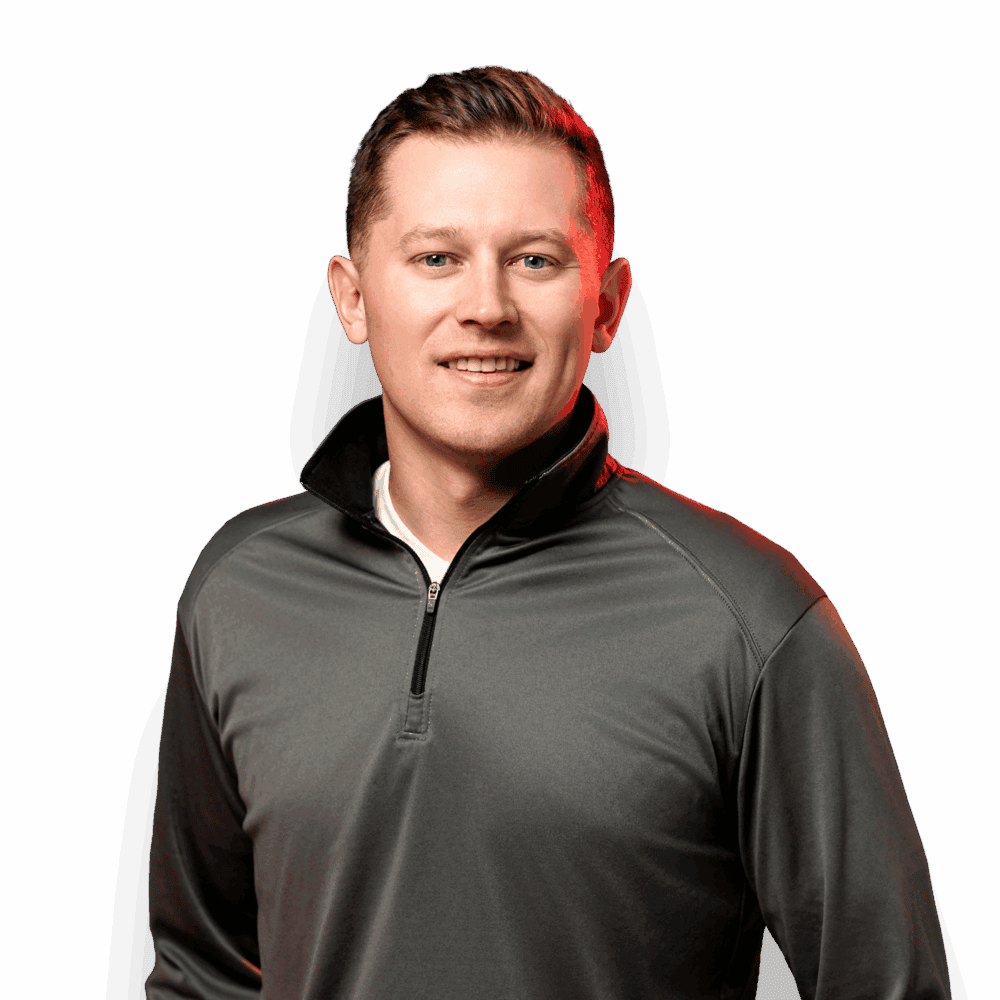 Nate Jean smiling in a gray quarter-zip pullover.