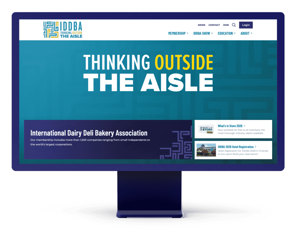 Desktop monitor displaying the IDDBA homepage with the headline “Thinking Outside the Aisle” and featured membership and event content.