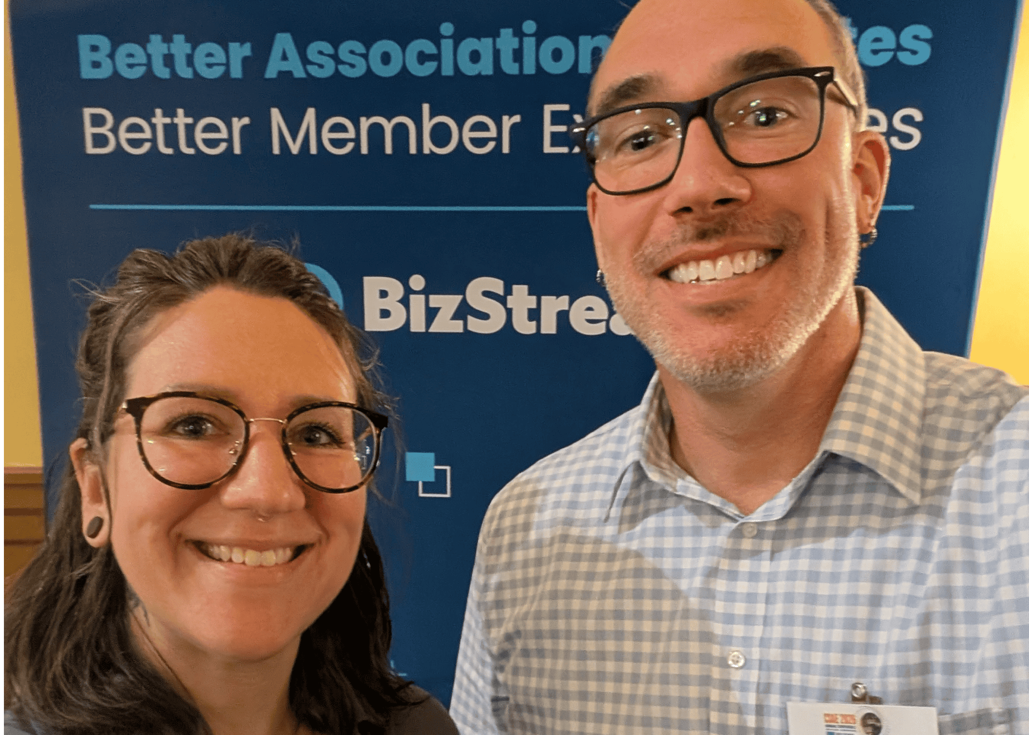 BizStream's Jordan and Drew smiling in front of a BizStream sponsor banner reading "Better Associations, Better Member Experiences" at the 2026 CSAE Annual Conference.