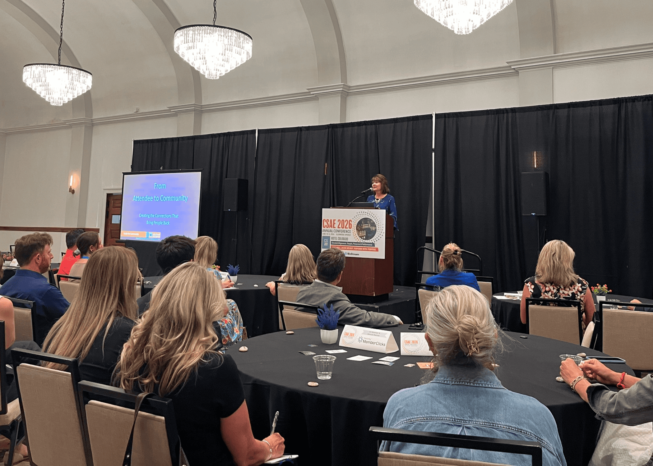A speaker presents a session titled "From Attendee to Community" to a full ballroom of association professionals at the 2026 CSAE Annual Conference at Hotel Colorado in Glenwood Springs, Colorado.