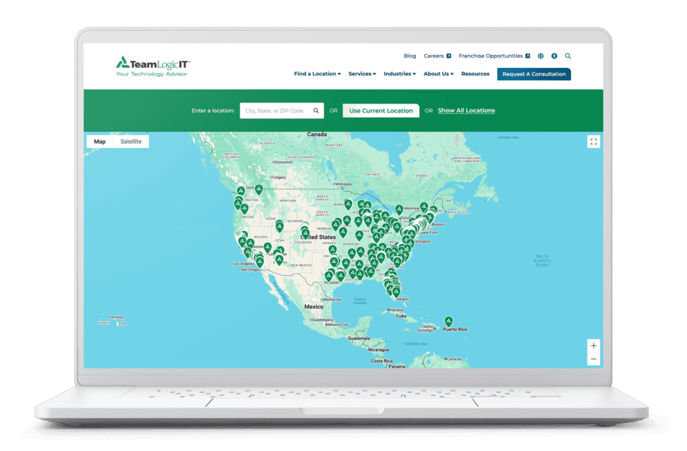 TeamLogic IT location finder displayed on a laptop, showing a Google Maps view with franchise location pins across the United States, Canada, and Puerto Rico.