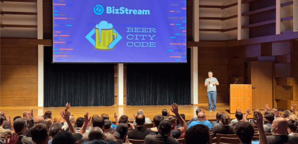 Brian on stage at Beer City Code with BizStream sponsor slide displayed