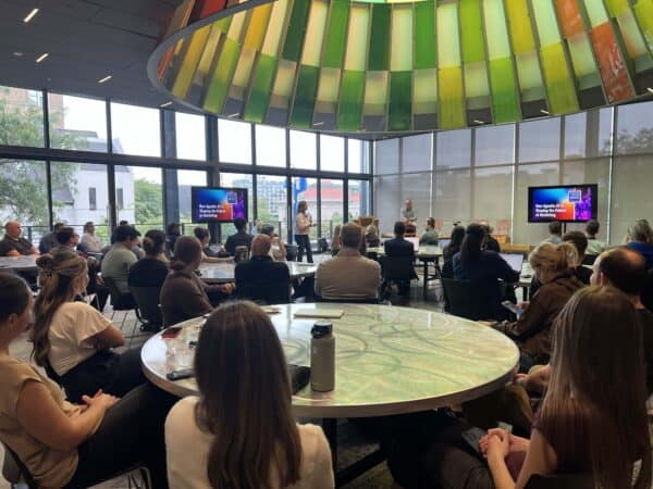 A full audience at BizStream's agentic AI marketing session during Tech Week Grand Rapids, held under the glass SkyCone at GRCC's Secchia Piazza.