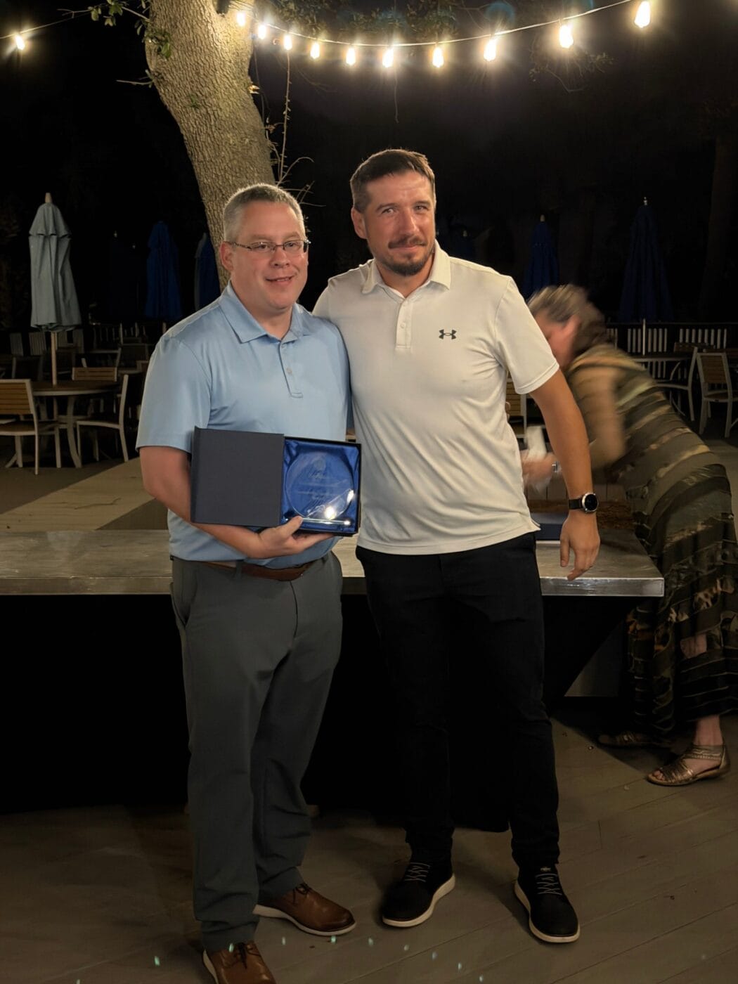 BizStream accepts the Kentico Partner Award for Best Community Leadership at the Kentico Connection 2026 awards dinner.