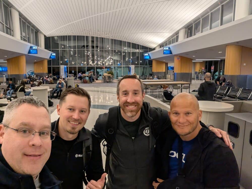 The BizStream team smiles for a selfie at the airport on the way to Kentico Connection 2026.