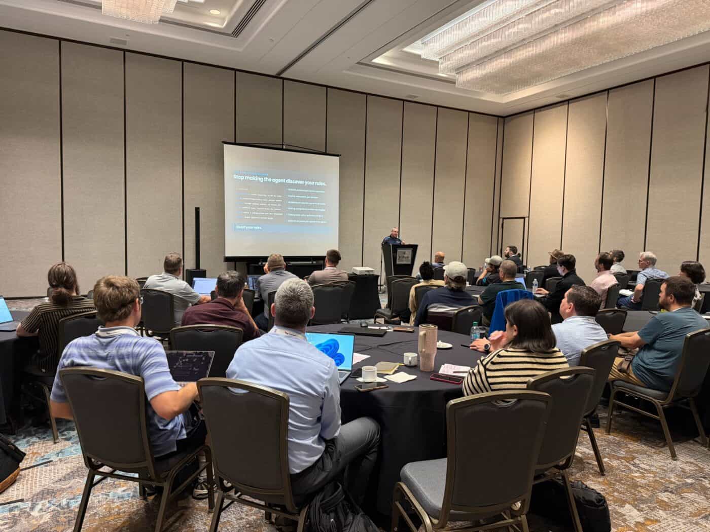 Brian McKeiver presents on context-engineered AI development to a full room at Kentico Connection 2026.