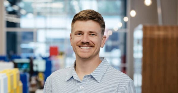 Smiling man in business casual attire at BizStream office.