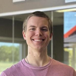 Joseph Heinz, BizStream's summer Developer intern from Hope College, smiling in the BizStream office lobby.